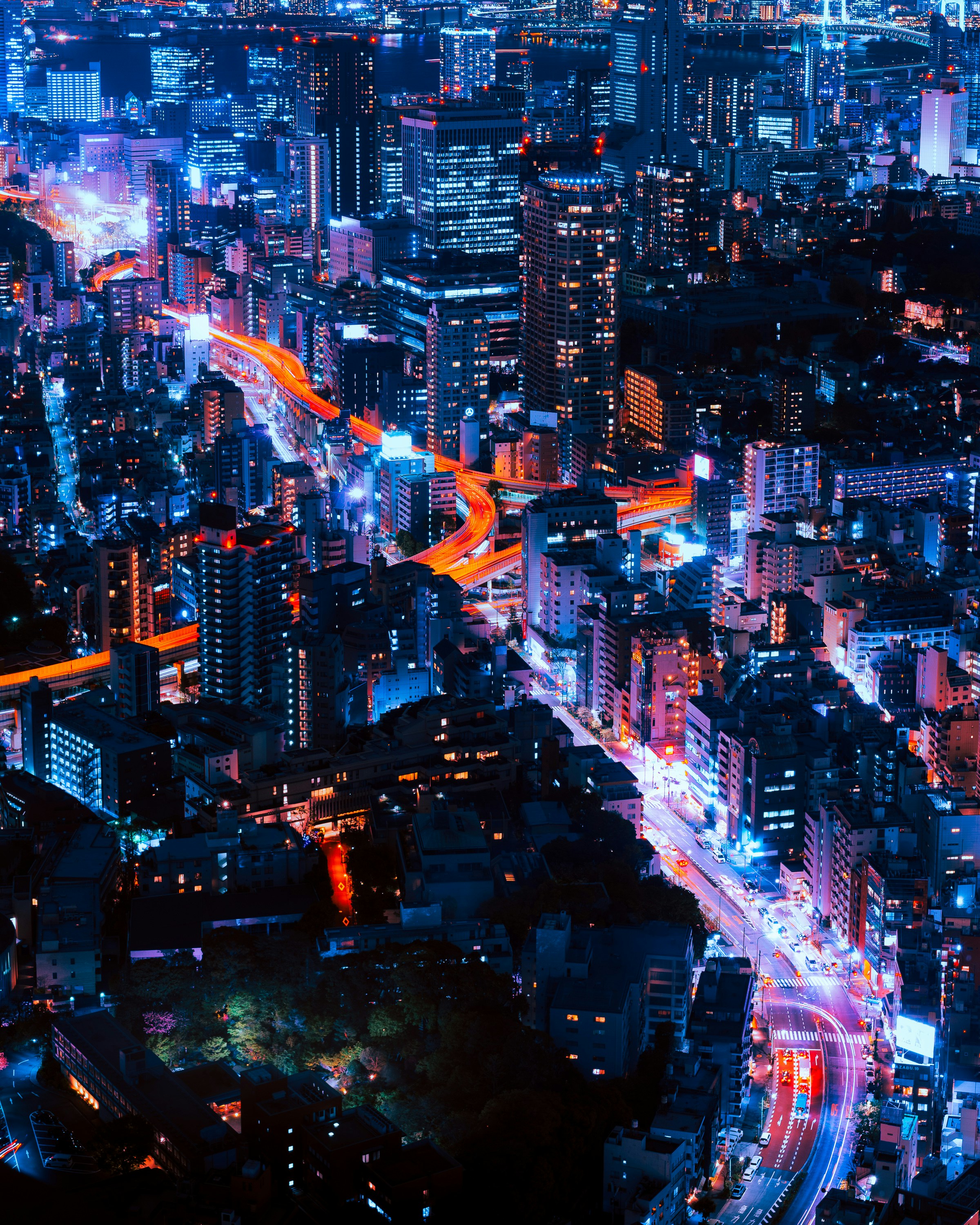Modern city skyline at night with light trails representing innovation and technology